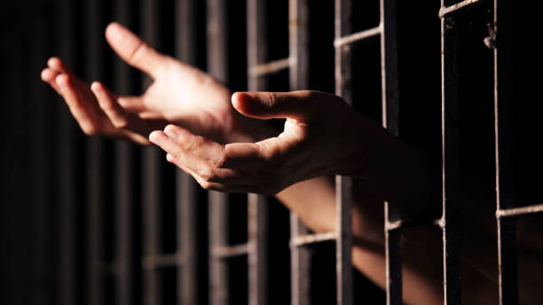 hands of prisoner in jail.