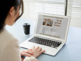 Asian women viewing real estate websites on a computer