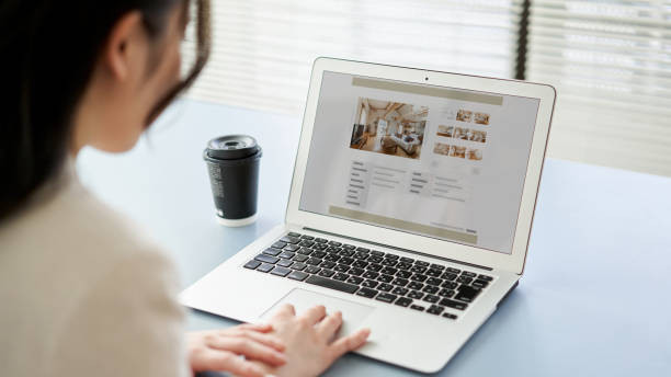 Asian women viewing real estate websites on a computer