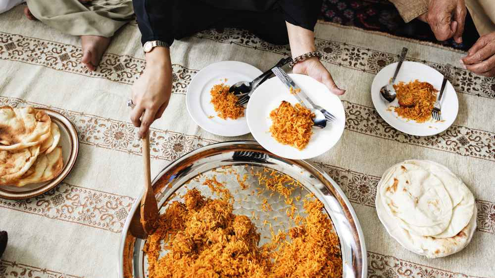 Muslim family having dinner on the floor
